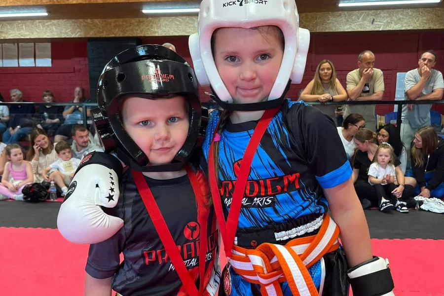 Two of Paradigm's youngest members with their competition medals